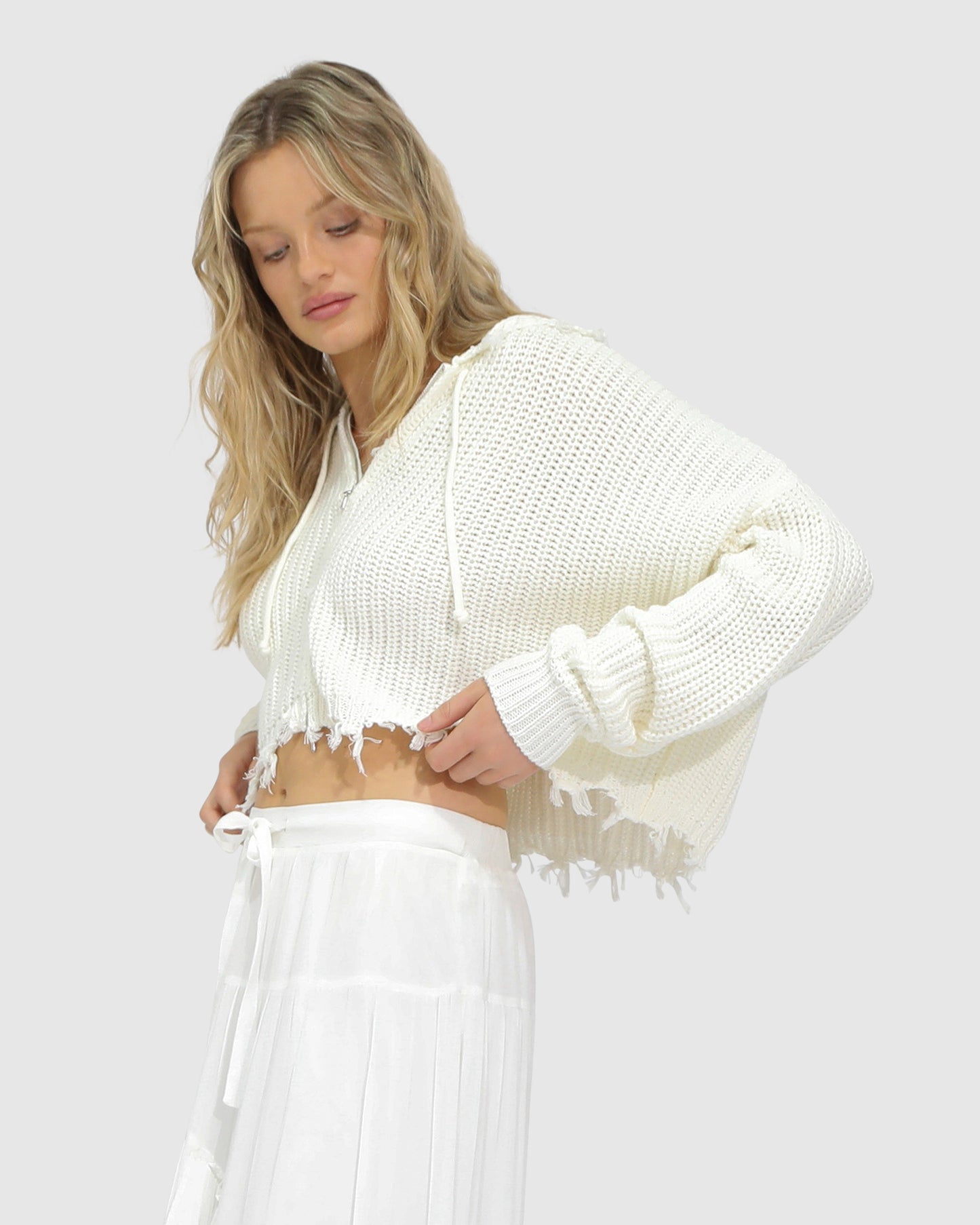 Close-up of the Another Love Fringe Knit Zip Cardigan in cream, showing chunky knit texture, zip closure, and fringe hem detail – Belle and Bloom knitwear.