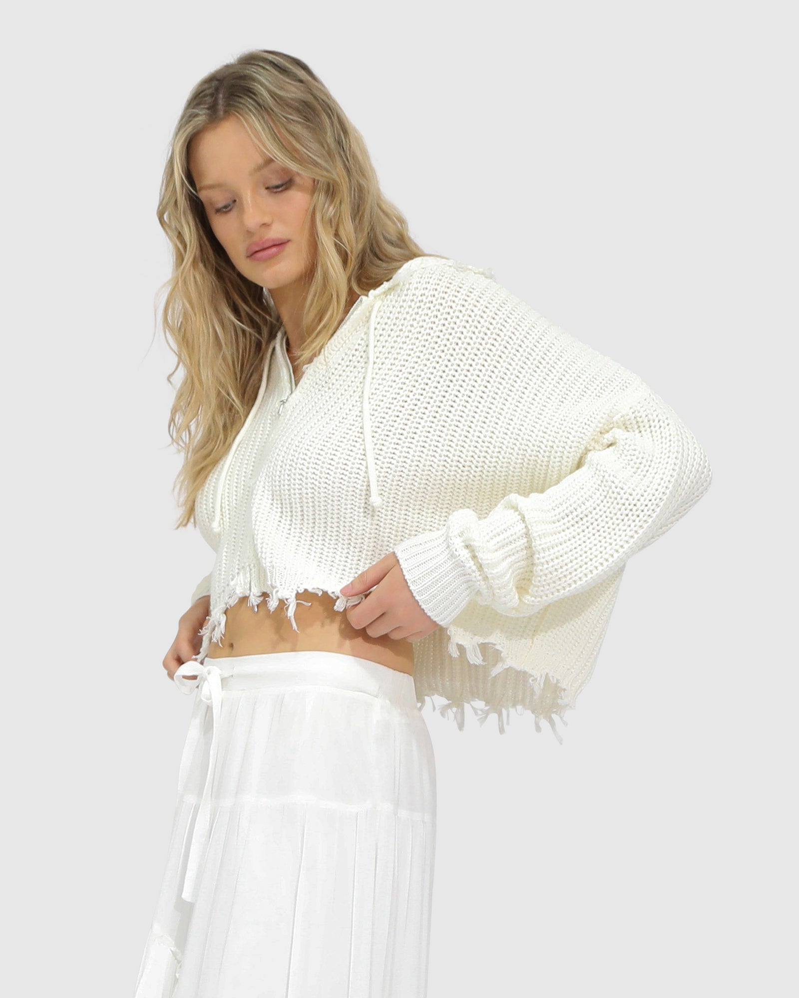 Close-up of the Another Love Fringe Knit Zip Cardigan in cream, showing chunky knit texture, zip closure, and fringe hem detail – Belle and Bloom knitwear.