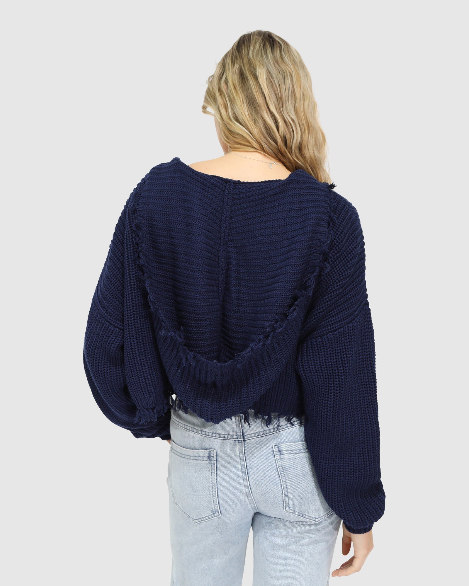 Back view of the Another Love Fringe Knit Zip Cardigan in navy, showcasing the chunky knit fabric, relaxed fit, and hood detail – Belle and Bloom women's cardigan.