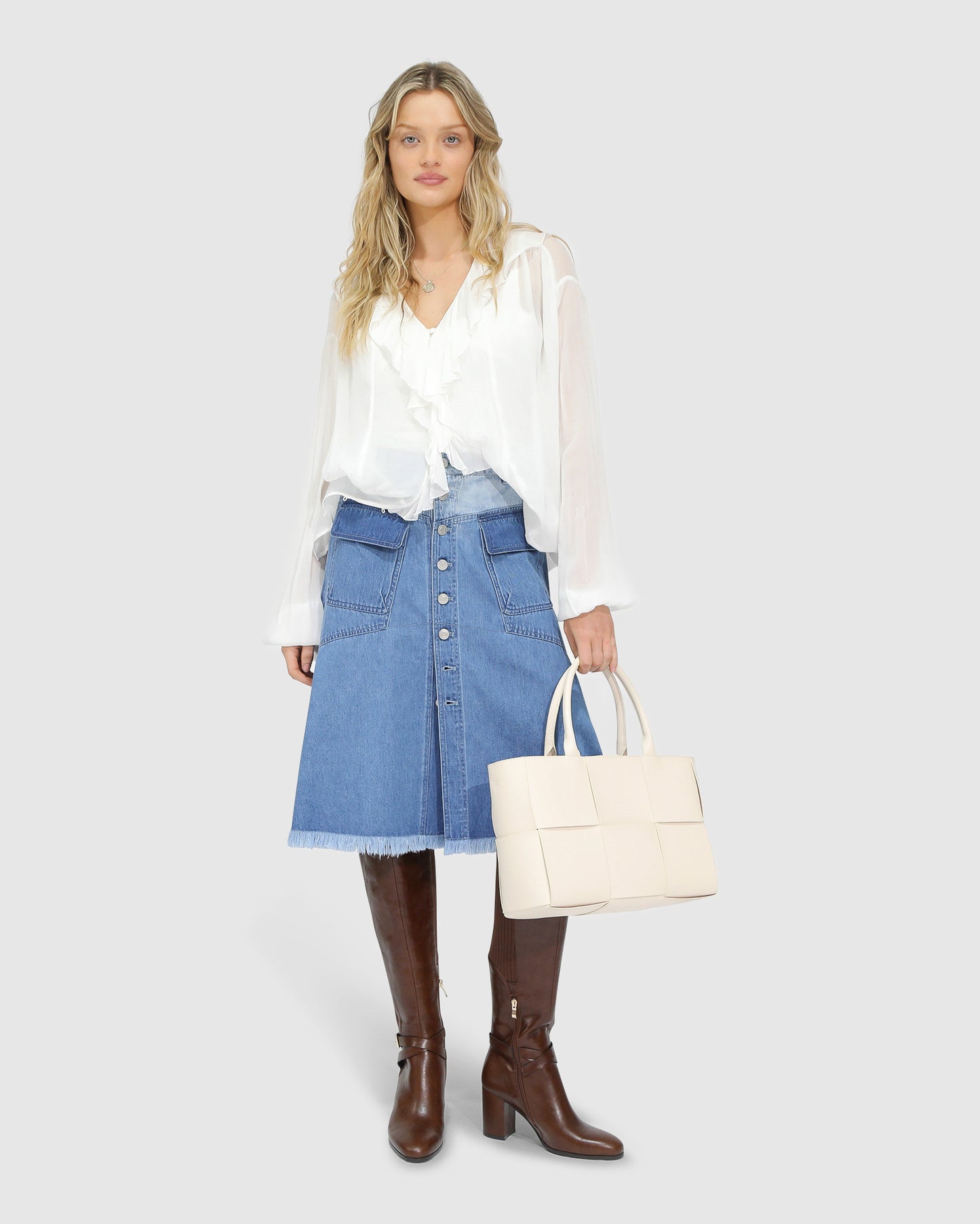 Belle and Bloom Let Me Wander button front denim midi skirt in stonewash blue, featuring raw hem and high waist.