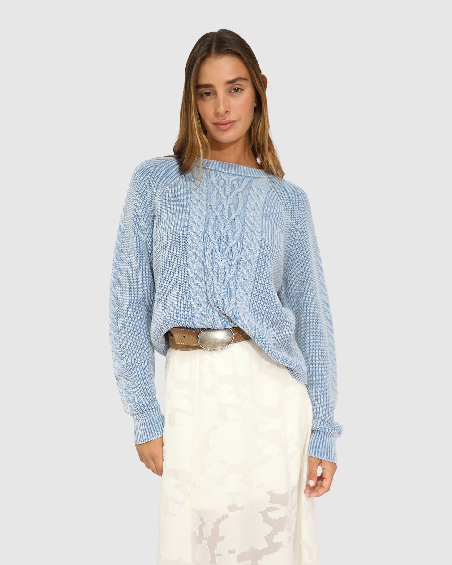 Women's cable knit sweater with garment-dyed finish and relaxed fit in light blue
