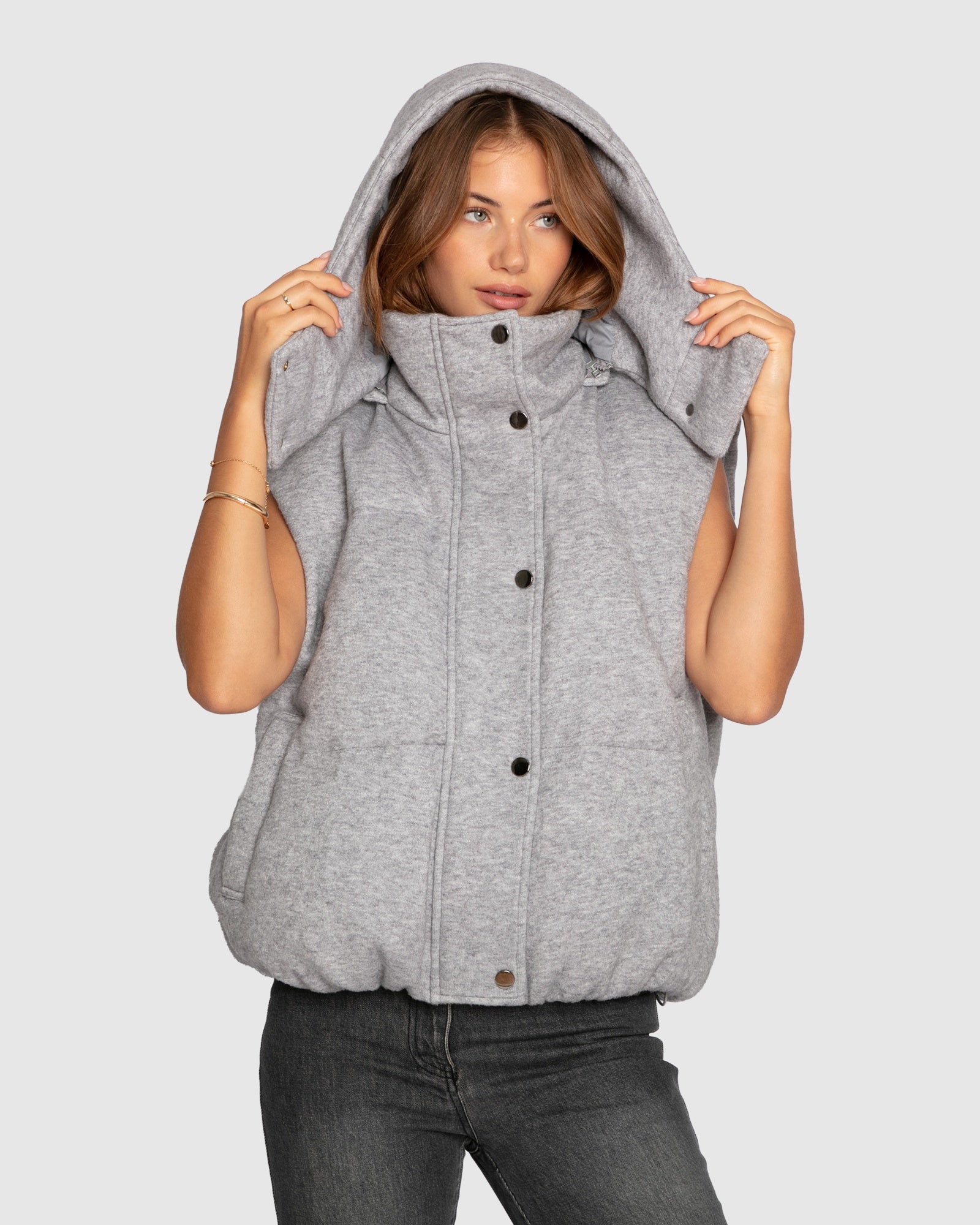 Women's hooded puffer vest with padded design and snap front in grey melange
