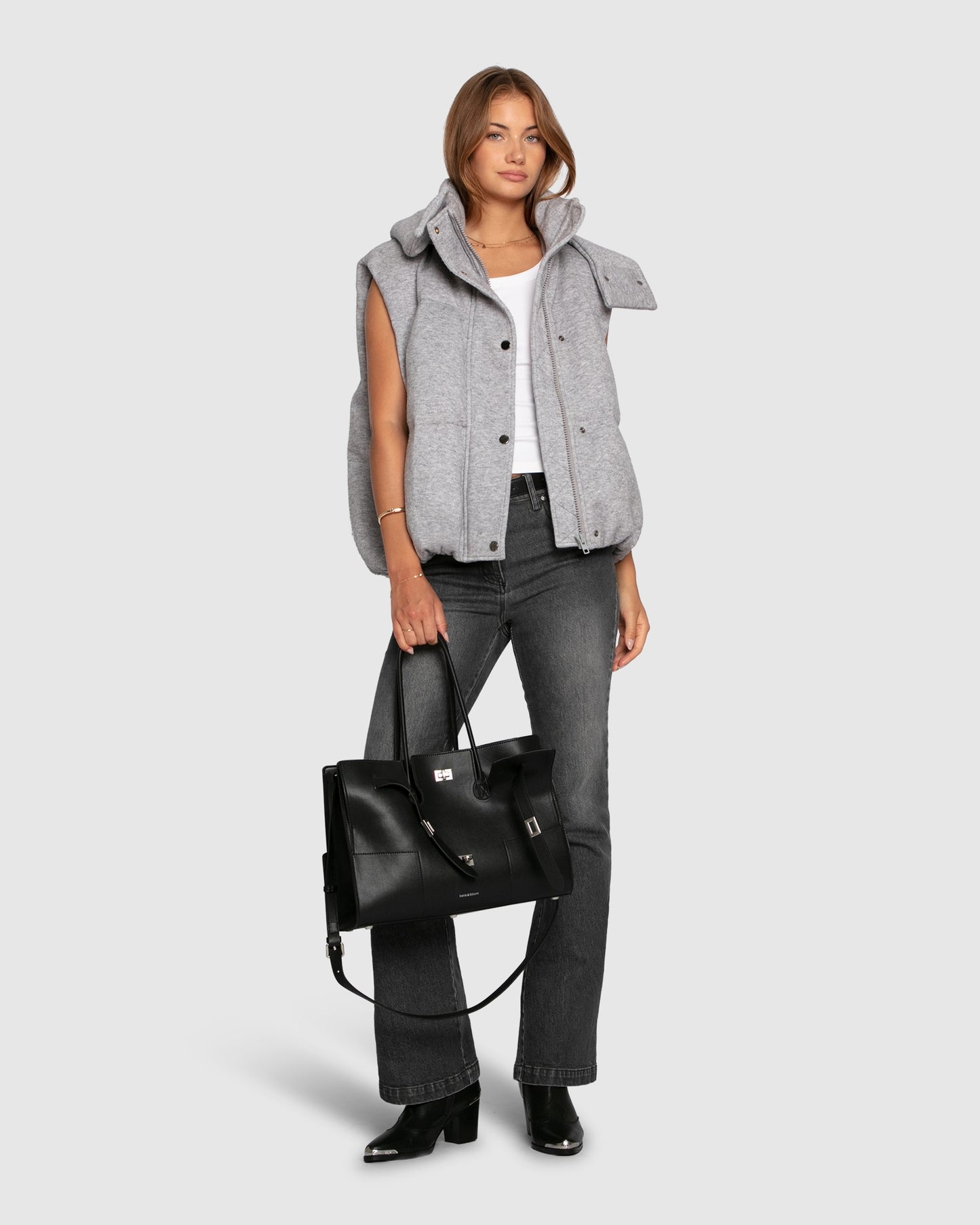 Woman wearing grey melange hooded puffer vest 
