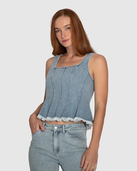 Close-up of fringed hem detail on Belle & Bloom Hold Me Brave Denim Top in mid-wash cotton.