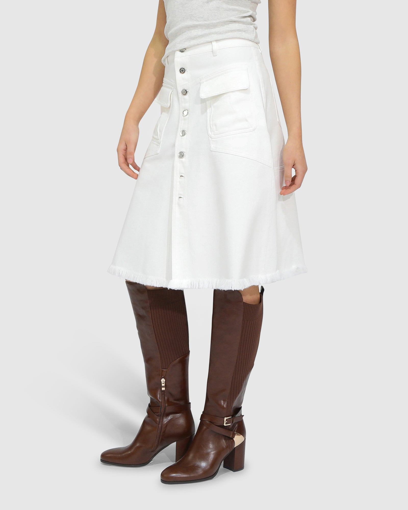 Close-up detail of button front on Belle and Bloom Let Me Wander off white denim midi skirt.