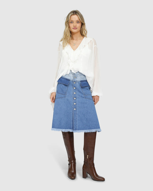 Belle and Bloom Let Me Wander button front denim midi skirt in stonewash blue, featuring raw hem and high waist.