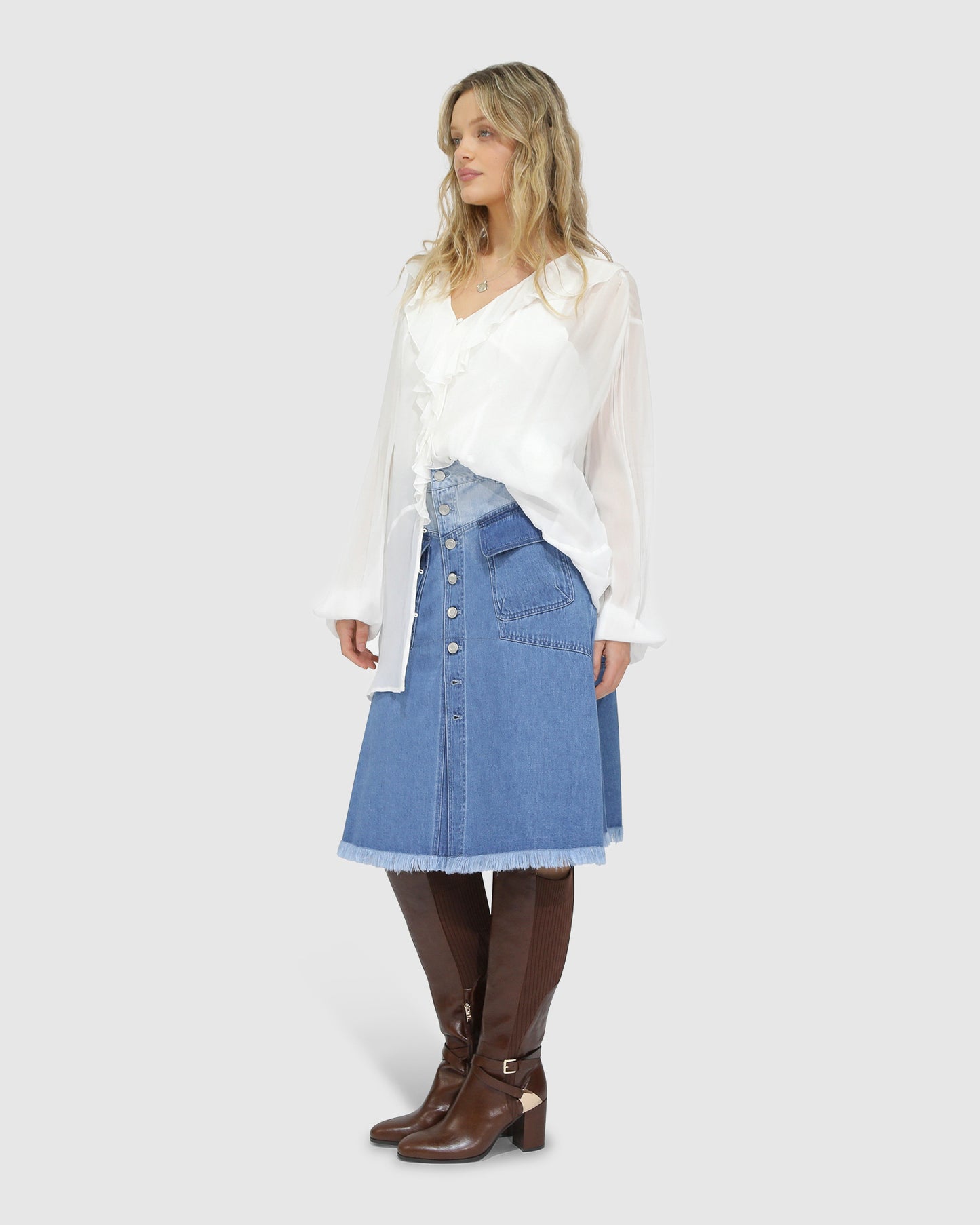 Side view of Belle and Bloom Let Me Wander denim midi skirt in stonewash with button front detailing and relaxed fit.