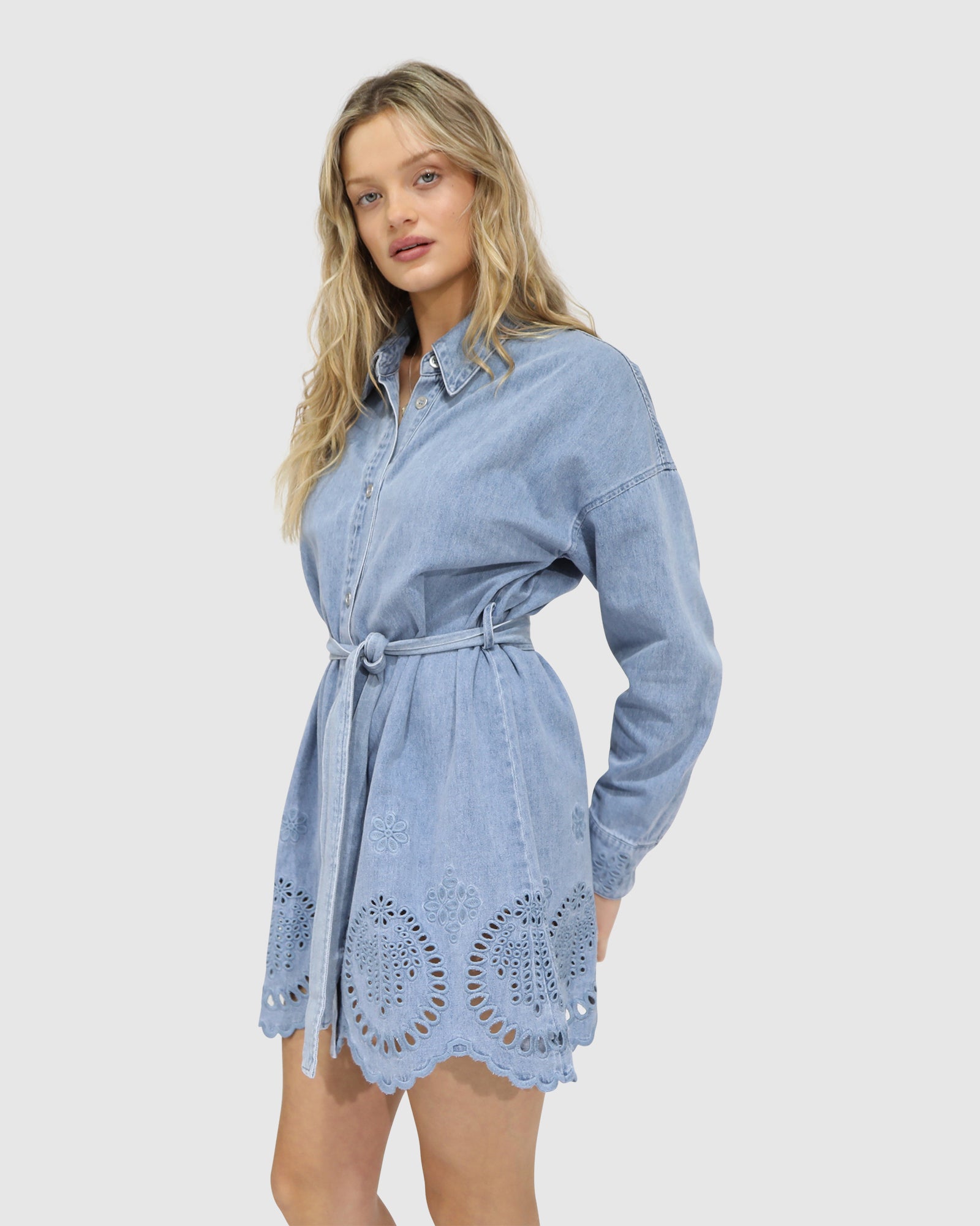Side view of the Sunday Somewhere Denim Broderie Shirt Mini Dress – puff sleeves, curved hem, flattering A-line silhouette, broderie anglaise detailing
