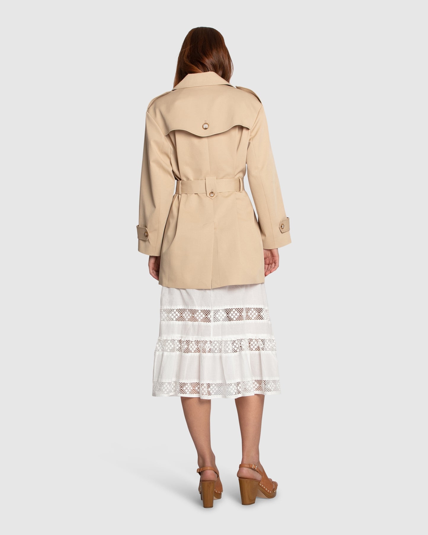 Back view of the Whispers of Verona Trench Coat in light camel, showcasing the storm flap, tailored seams, and longline hem – Belle and Bloom women’s outerwear.